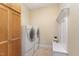 Bright laundry room featuring cabinetry, washer, dryer and a built-in bench for convenience at 2000 Monthaven Dr, Wake Forest, NC 27587
