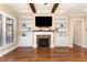 Living room with hardwood floors, stone fireplace, built-in shelving, and lots of natural light at 2000 Monthaven Dr, Wake Forest, NC 27587