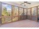 Screened-in porch with ceiling fan and wooded views provides a relaxing outdoor space at 2000 Monthaven Dr, Wake Forest, NC 27587