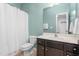 Neat bathroom with white shower curtain, a toilet, and a vanity with dark wood cabinets at 214 S Camellia St, Chapel Hill, NC 27516