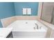 Bathroom featuring a luxurious soaking tub with tile surround at 214 S Camellia St, Chapel Hill, NC 27516