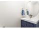 Bathroom with a blue vanity, stylish oval mirror, and brushed nickel fixtures at 214 S Camellia St, Chapel Hill, NC 27516