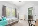 Cozy bedroom with natural light, complemented by a white dresser for storage at 214 S Camellia St, Chapel Hill, NC 27516