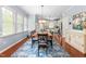 Open dining room with a large wooden table and chairs leading into the kitchen at 214 S Camellia St, Chapel Hill, NC 27516