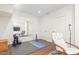 Bright exercise room with wood floors, large mirror, weights, and yoga mat for at-home workouts at 214 S Camellia St, Chapel Hill, NC 27516