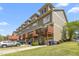 View of townhomes showcasing private balconies, garages, landscaping and street view at 214 S Camellia St, Chapel Hill, NC 27516