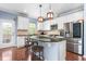 Modern kitchen featuring white cabinets, granite countertops, and stainless steel appliances at 214 S Camellia St, Chapel Hill, NC 27516
