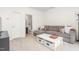 Bright living area boasts a comfortable couch and convenient access to an adjacent bathroom at 214 S Camellia St, Chapel Hill, NC 27516