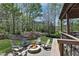 Outdoor fire pit on a stone patio, surrounded by Adirondack chairs and lush landscaping at 216 Bella Rose Dr, Chapel Hill, NC 27517
