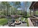 Outdoor fire pit on a stone patio, surrounded by Adirondack chairs and lush landscaping at 216 Bella Rose Dr, Chapel Hill, NC 27517