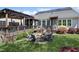 Large backyard with stone patio, fire pit, Adirondack chairs, and beautiful pergola at 216 Bella Rose Dr, Chapel Hill, NC 27517