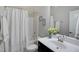 Bright bathroom with a shower-tub combo, dark vanity, and fresh decor at 216 Bella Rose Dr, Chapel Hill, NC 27517