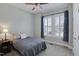Cozy bedroom with a ceiling fan, grey walls, and large window offering lots of natural light at 216 Bella Rose Dr, Chapel Hill, NC 27517