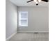 Minimalist bedroom with a ceiling fan and window for natural light at 216 Bella Rose Dr, Chapel Hill, NC 27517
