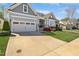Stunning home exterior with gray siding, white trim, attached garage, and professionally landscaped front yard at 216 Bella Rose Dr, Chapel Hill, NC 27517