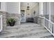 Inviting front porch with stone accents, a decorative wreath, and comfortable seating at 216 Bella Rose Dr, Chapel Hill, NC 27517