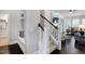 Hallway featuring hardwood floors, stairs, and a view into the living room at 216 Bella Rose Dr, Chapel Hill, NC 27517