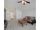 Spacious living room with neutral carpet, ceiling fan, and comfortable futon at 216 Bella Rose Dr, Chapel Hill, NC 27517