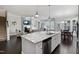 Open-concept living room with kitchen island, fireplace, and dark hardwood floors at 216 Bella Rose Dr, Chapel Hill, NC 27517