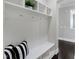 Convenient mudroom area with built-in bench, hooks, and storage shelves at 216 Bella Rose Dr, Chapel Hill, NC 27517