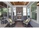 Cozy screened porch with stone fireplace, ceiling fan, and comfortable seating at 216 Bella Rose Dr, Chapel Hill, NC 27517