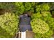 Overhead view of a home nestled among lush trees, offering privacy and charm at 216 Harvester Dr, Holly Springs, NC 27540