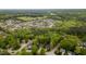 An aerial view of a neighborhood with mature trees and well-maintained homes at 216 Harvester Dr, Holly Springs, NC 27540