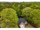 Beautiful aerial view of a home surrounded by mature trees in a quiet neighborhood at 216 Harvester Dr, Holly Springs, NC 27540