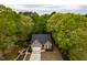 A high aerial view of a home with mature landscaping and a large driveway at 216 Harvester Dr, Holly Springs, NC 27540