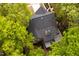 An aerial perspective showcases a home surrounded by mature trees and a manicured lawn at 216 Harvester Dr, Holly Springs, NC 27540