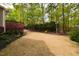 Spacious backyard featuring a well-maintained lawn, wood deck and mature trees at 216 Harvester Dr, Holly Springs, NC 27540