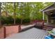 Inviting backyard deck with seating and a brick patio, perfect for outdoor entertaining at 216 Harvester Dr, Holly Springs, NC 27540