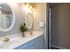 Elegant bathroom with double sinks, white cabinets, gold fixtures, and decorative mirrors at 216 Harvester Dr, Holly Springs, NC 27540