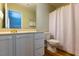 Well-lit bathroom featuring a modern vanity and a shower with a curtain at 216 Harvester Dr, Holly Springs, NC 27540