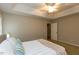 Calm bedroom with neutral decor, a tray ceiling, a fan, and comfortable linens at 216 Harvester Dr, Holly Springs, NC 27540