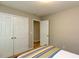 Bright bedroom featuring carpet, and double door closet for ample storage space at 216 Harvester Dr, Holly Springs, NC 27540
