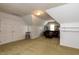 Spacious bonus room with carpet, a cozy seating area, and built-in shelving at 216 Harvester Dr, Holly Springs, NC 27540