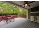 Relaxing covered deck featuring outdoor seating, a ceiling fan, and a scenic wooded view at 216 Harvester Dr, Holly Springs, NC 27540