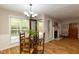 Bright dining area featuring a glass table, four chairs, and hardwood floors at 216 Harvester Dr, Holly Springs, NC 27540