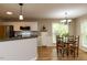 Bright dining area featuring white cabinets, stainless appliances, and a view of the backyard at 216 Harvester Dr, Holly Springs, NC 27540