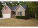 Side view of cozy home featuring manicured lawn and neutral siding with red shutters at 216 Harvester Dr, Holly Springs, NC 27540
