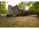Charming home exterior with a well-manicured lawn, wooden deck and mature trees at 216 Harvester Dr, Holly Springs, NC 27540