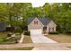 Charming single Gathering home featuring a 1-car garage, landscaped yard, and neutral exterior with red shutters at 216 Harvester Dr, Holly Springs, NC 27540