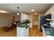 Well-lit kitchen featuring white cabinetry, green countertops, and modern appliances at 216 Harvester Dr, Holly Springs, NC 27540
