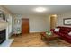 Bright living room with hardwood floors, fireplace, and neutral walls at 216 Harvester Dr, Holly Springs, NC 27540