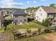 A spacious, fenced backyard with a patio, grill, and young trees offers privacy and space at 218 Maple Walk St, Durham, NC 27703
