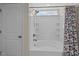 Clean bathroom featuring a shower-tub combo with white tile and built in shelving at 218 Maple Walk St, Durham, NC 27703