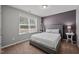 Bedroom with a comfortable bed, neutral decor, and ample natural light from a large window at 218 Maple Walk St, Durham, NC 27703