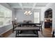 Elegant dining room with coffered ceilings, a chandelier, and a dark wood table at 218 Maple Walk St, Durham, NC 27703