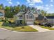 Beautiful home with a two-car garage, a cozy front porch, and a well-manicured lawn at 218 Maple Walk St, Durham, NC 27703